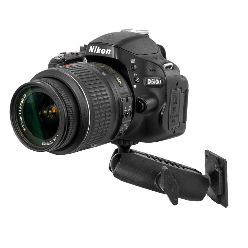 A Nikon D5100 DSLR with lens is secured to a black Camera Wall Mount for Nikon, Sony, Canon, Fujifilm, and Olympus cameras and video cameras.
