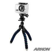 A Mini Tripod Mount for GoPro HERO Action Cameras with black and blue segmented legs and gray rubber tips is shown on a white background. A small camera is mounted on the flexible tripod. The Arkon logo appears in the bottom right corner.