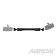 The 10 inch Double Socket Arm Extension Pole with 25mm (1 inch) Ball Ends features a metal spring-loaded connector rod, two ball joints, and comes with semi-transparent gray mounting brackets designed for the Arkon Robust Mount 25mm pattern. ARKON logo shown bottom right.