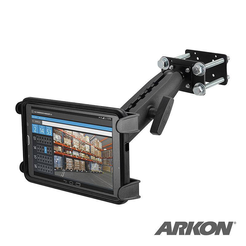 The Slim-Grip® Tablet Holder with Forklift Front Guard Mount and 10.25 Metal Arm securely holds a tablet displaying warehouse inventory. The sturdy adjustable arm attaches to metal surfaces, ideal for busy workspaces. Arkon logo shown bottom right.
