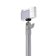 The 20mm Metal Ball to 1/4-20 Camera Bolt Adapter lets you secure a compact digital camera to a silver telescopic pole with an adjustable joint and tightening knob for versatile mounting options.