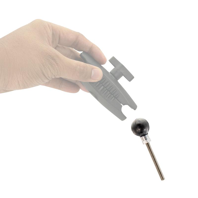 A hand holds a 25mm (1 inch) Ball Adapter with 1/4-20 female threaded hole and hex post above a separate ball-and-socket screw mount, both isolated on a white background.