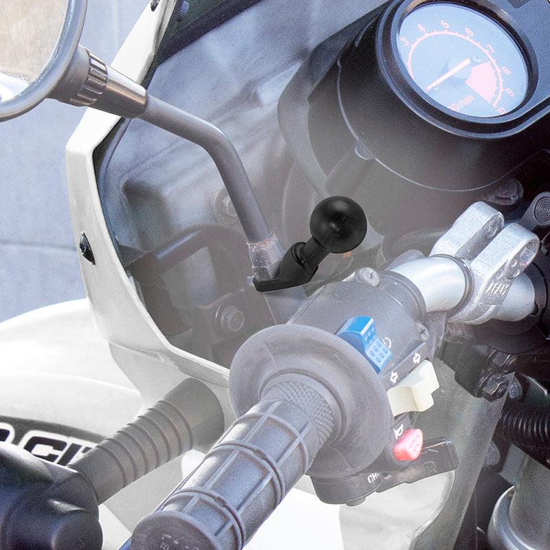 Close-up of a motorcycle handlebar highlighting the throttle grip, switches, part of the speedometer, and a rearview mirror fitted with the 25mm Ball to 9mm Angled Bolt Head Adapter near the rider’s right hand.