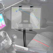A tablet is held by the Slim-Grip® Tablet Holder with Seat Rail Mount and 22 Bendable Arm, displaying a map app next to the center console. The car’s interior also shows the gear shift, part of the dashboard, and a red-striped seat.