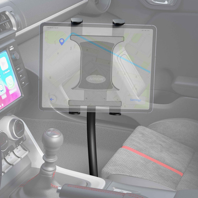 A tablet is held by the Slim-Grip® Tablet Holder with Seat Rail Mount and 22 Bendable Arm, displaying a map app next to the center console. The car’s interior also shows the gear shift, part of the dashboard, and a red-striped seat.