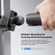 Hand holding a tool with modular mounting system for evolving work environments, featuring XMS branding.