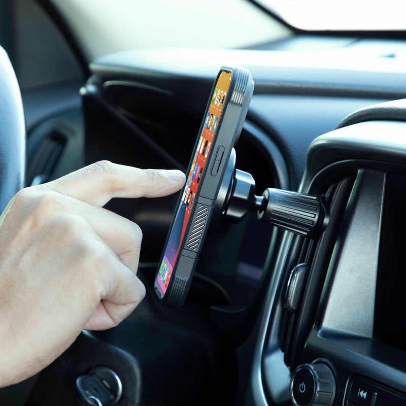 A hand reaches to tap a smartphone on the Magnetic Phone Holder with Vent Mount – MagSafe Compatible, mounted horizontally. The phone’s home screen is displayed, and the car dashboard can be seen in the background.