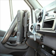 A LockVise™ Metal XL Locking Tablet Holder with Drill Base Mount secures a rugged tablet to the dashboard near the steering wheel and air vent, with control buttons visible below.