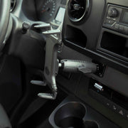 A close-up of a car interior shows the Slim-Grip® Tablet Holder with Metal Drill Base Mount installed on the dashboard near the steering wheel and air vent, with buttons and cupholders visible.