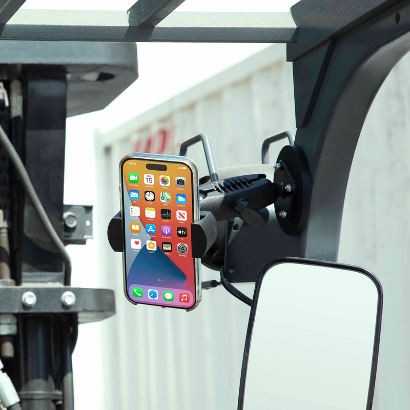 A RoadVise® XL Phone and Midsize Tablet Magnetic Mount secures a smartphone with a heavy-duty magnetic base to the vehicles frame near the rear-view mirror, displaying its home screen apps.