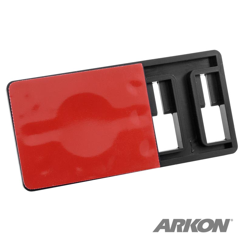 The Adhesive Security Plate with Slot for Use with Cables and Dual T-Slot for Mounting is a black plastic rectangular plate with a red adhesive pad on one side, shown on a white background with the ARKON logo in the bottom right corner.