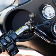 Close-up of a motorcycle handlebar showing the Aluminum Motorcycle Handlebar Mount - 25mm (1 inch) Compatible, with dashboard gauges and control buttons on the left handle.