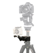 A Canon DSLR sits atop a camera tripod, while a GoPro-style action camera is attached to the side using the Clamp Mount with GoPro Mount. The main camera and tripod are partially faded to emphasize the clamp.