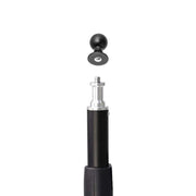 A black and silver Female Camera 1/4-20 Threaded Pattern to 22mm Ball Adapter is displayed on a white background, with its detachable round black 22mm ball pedestal mount positioned above the extendable pole, ready for attachment.