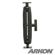 A Heavy Duty Metal AMPS Mounting Pedestal - 38mm Ball Compatible is shown vertically. It has a black adjustable arm with two joints, a side knob, and a metal drill base for secure installation. ARKON is in large gray letters at the bottom right.