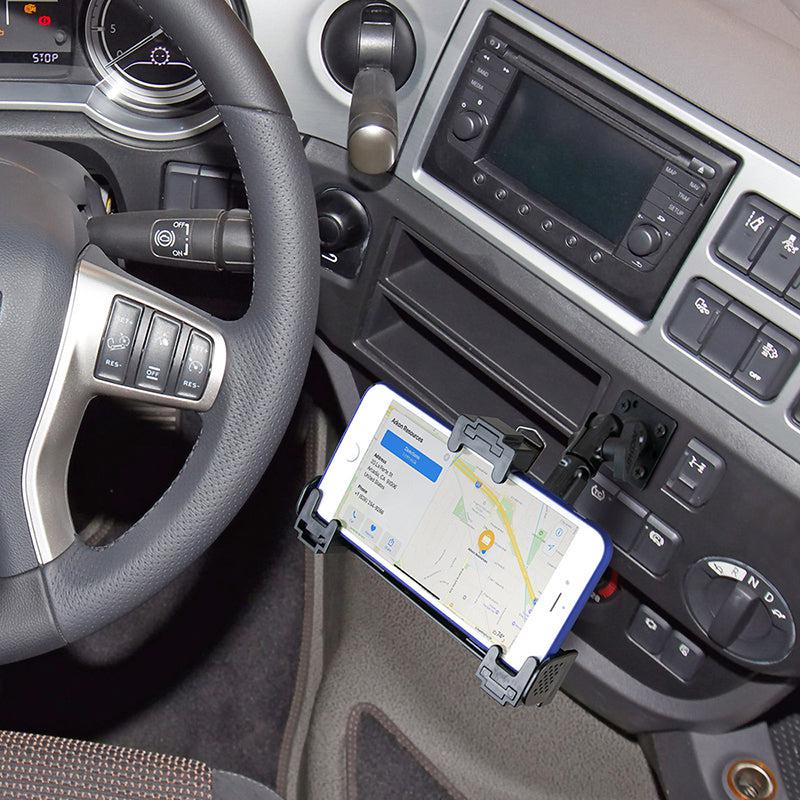 A smartphone displaying a map is secured in the LockVise™ Locking Phone Mount with 4-Hole AMPS Drill Base on the car dashboard, positioned next to the steering wheel and various control buttons.