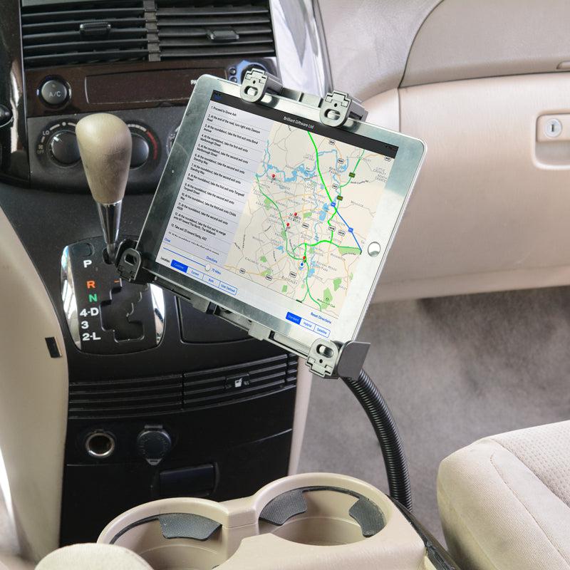 The LockVise™ Locking Seat Rail Tablet Mount with a 22 gooseneck secures a tablet showing navigation near the gear shift in a beige interior with cup holders and gear indicators beside the dashboard.