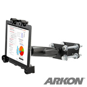 A black LockVise™ Locking Forklift Front Guard Tablet Mount with 5 Robust™ Shaft securely holds a tablet showing charts. The mount, attached to a metal bracket with bolts, is ideal as a warehouse tablet holder. The Arkon logo appears at the bottom right.