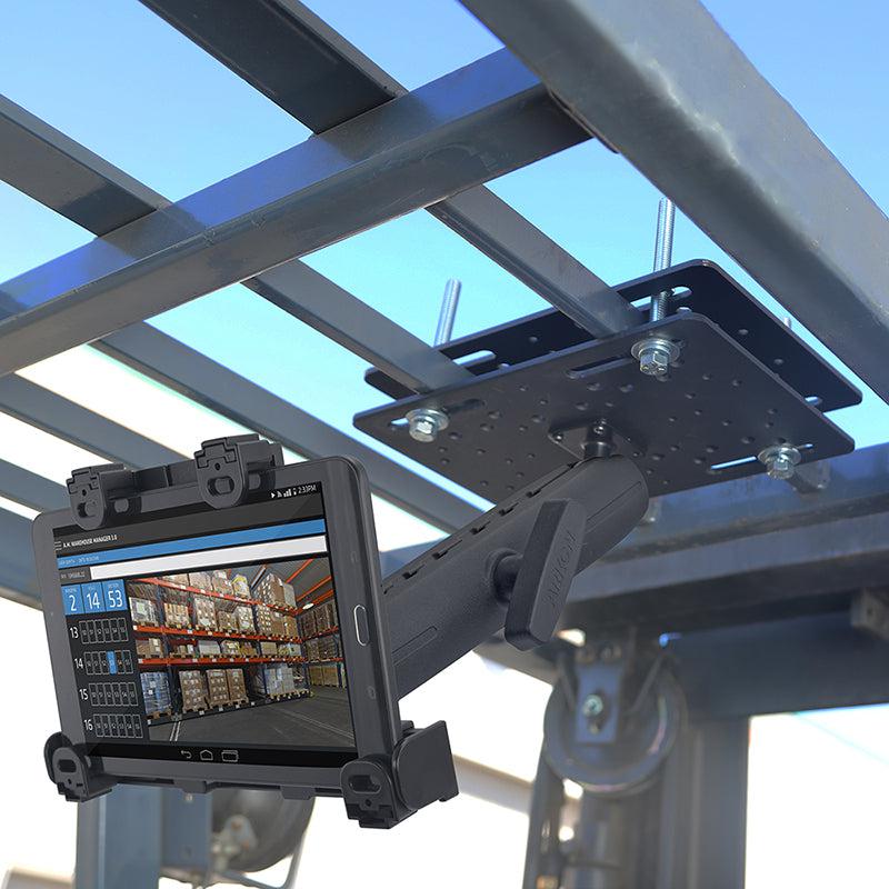 A tablet is attached to the overhead frame using the LockVise™ Locking Forklift Overhead Guard Tablet Mount with 8.5 Metal Shaft, displaying a warehouse inventory management screen with shelves and item listings.