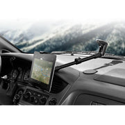 A Long Arm Windshield Suction Tablet Mount for iPad, Note, and more holds a tablet displaying a map navigation app on the dashboard, with the vehicle’s interior and a blurred outdoor landscape visible in the background.