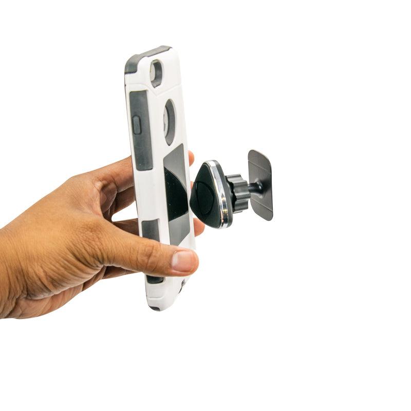 A hand holds a smartphone near the Magnetic Phone Adhesive Mount Holder for iPhone, Galaxy, and Note, attached to a car vent, demonstrating this universal mount’s convenience and versatility.