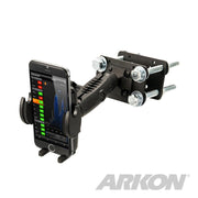 The Mega Grip™ Forklift Front Guard Mount is a black adjustable rugged phone holder with bolts, securely holding a smartphone displaying a graph. The ARKON logo appears in the bottom right corner.