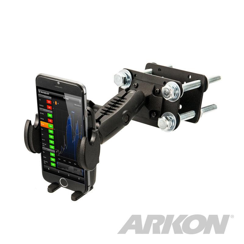 The Mega Grip™ Forklift Front Guard Mount is a black adjustable rugged phone holder with bolts, securely holding a smartphone displaying a graph. The ARKON logo appears in the bottom right corner.