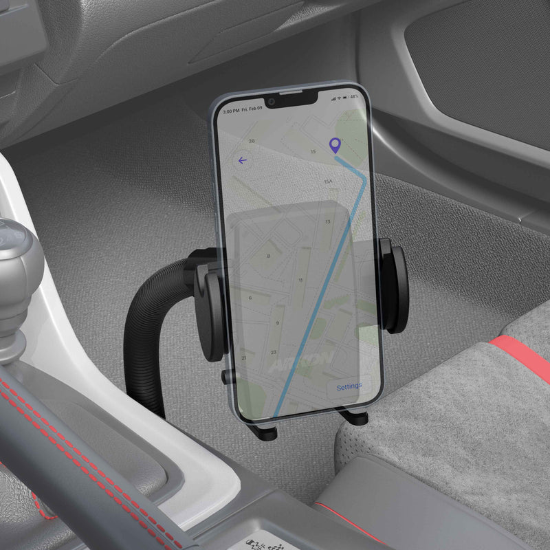 A smartphone shows a navigation map, secured in the Mega Grip™ Phone Holder with Car Seat Rail Mount and 18 Gooseneck, attached near the gear shift and seat, against visible gray and red seat upholstery.