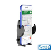 A smartphone in a black Mega Grip™ Universal Phone Holder - 4-Hole AMPS Compatible displays a navigation app with map and route details. The device is vertically positioned against a white background, Arkon Mounts logo at bottom right.