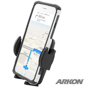 A smartphone displaying GPS directions is secured in the Mega Grip™ Universal Phone Holder for iPhone, Galaxy, and Note, with the ARKON logo visible in the bottom right of the screen.