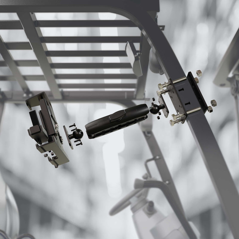 The LockVise™ Metal Locking Forklift Front Guard Tablet Mount with 3.75 Shaft, shown exploded with camera and brackets, hovers in front of a metal framework on industrial equipment in a blurred warehouse setting.