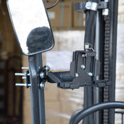 A close-up of the LockVise™ Metal Locking Forklift Front Guard Tablet Mount with a secure mechanism and 5 Metal Robust™ Shaft, attached to a vertical post near a rectangular mirror.