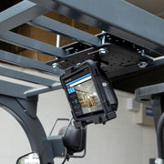 A LockVise™ Metal Locking Forklift Overhead Guard Tablet Mount with 5 Metal Robust™ Shaft secures a tablet under a forklifts overhead guard, displaying a warehouse management interface on the screen.