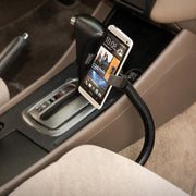 The Mobile Grip 2 Seat Rail or Floor Car Mount securely holds your iPhone, Galaxy, Note, and more near the gear shift for easy driver access. The car interior includes beige seats and a black center console for a sleek look.