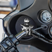 A close-up of a motorcycle handlebar with a control panel and dashboard featuring gauges, plus a Motorcycle or Bicycle Handlebar Mount - 25mm (1 inch) Ball Compatible for securing accessories like phone holders.