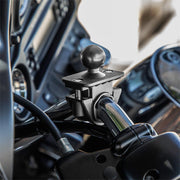 A Motorcycle or Bicycle Handlebar Mount - 25mm (1 inch) Ball Compatible is securely attached to the chrome motorcycle handlebar, ready to hold devices or accessories. The dashboard can be seen in the background.