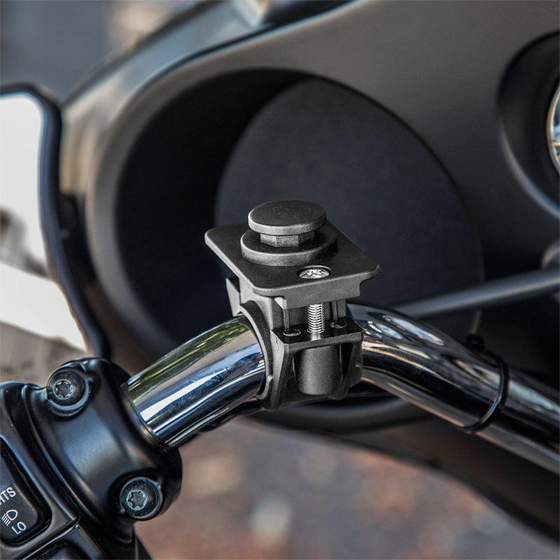 Close-up of the OCTO™ Series Motorcycle or Bicycle Handlebar Mount attached to chrome handlebars, with dashboard and controls in the background; features an octagon pattern for secure smartphone placement.