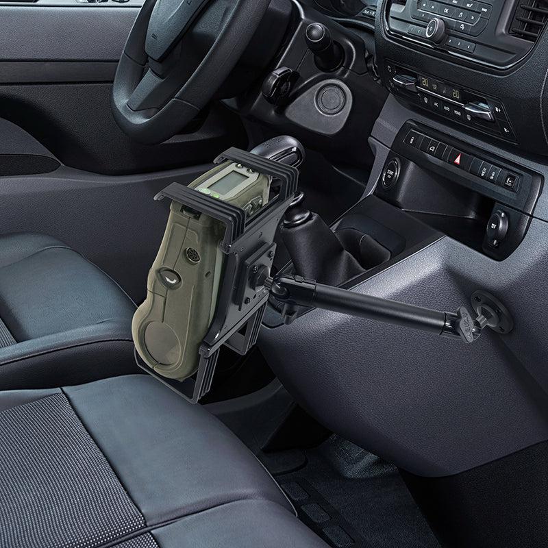 A Portable Mobile Printer Car & Truck Mount with Drill Base for Zebra, Epson, and Brother printers is installed on the dashboard above the center console and gear shift, near the drivers seat in a vehicle interior.