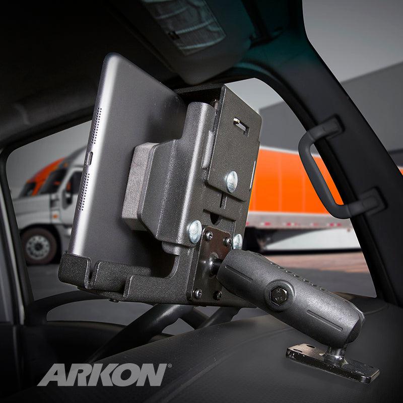 A LockVise™ Metal Locking Tablet Mount with Security Bundle for Commercial and Enterprise (Android compatible) is dashboard-mounted in a vehicle, with a large truck outside the window. The ARKON logo appears at the bottom left.