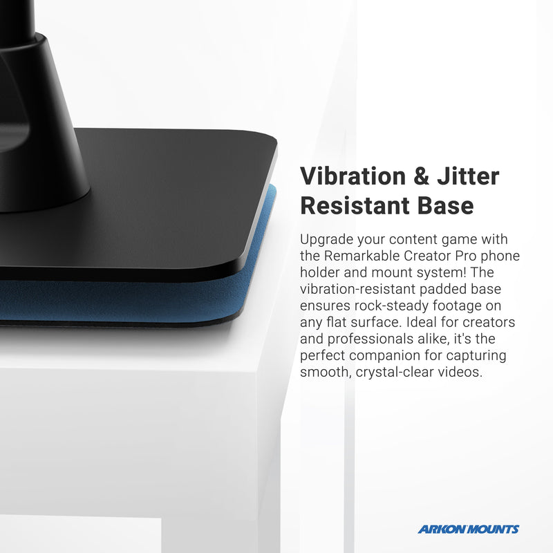 Close-up of the Remarkable Creator™ Cookie Decorators Mount Stand for Phones and Pico Projectors on a white table, showing its blue, vibration-resistant padding for stable video recording. Arkon Mounts logo is visible in the corner.