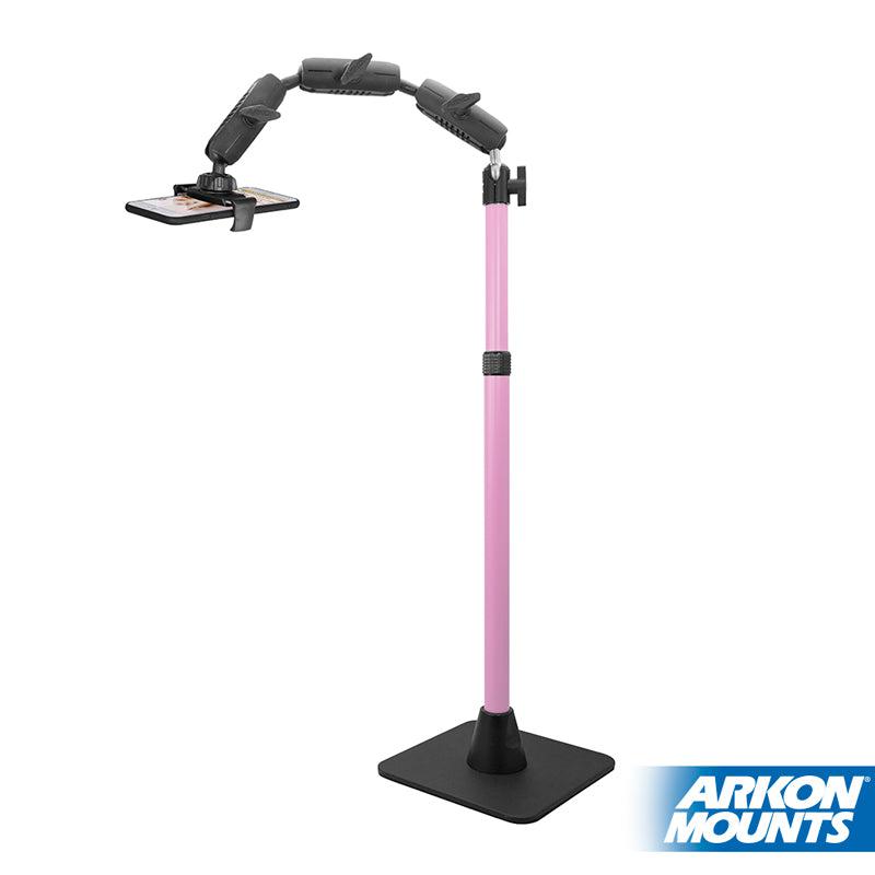 The Remarkable Creator™ Pro Mount with Pink Extension Pole features a pink adjustable stand, black flexible arm, and stable flat black base—ideal for content creators to hold smartphones horizontally. The Arkon Mounts logo is in the bottom right corner.