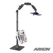 The Remarkable Creator™ Pro+Plus Mount w/Ring Light holds a smartphone overhead and a tablet mid-level for content creation, both with vivid screens. The ARKON logo is at the bottom right.