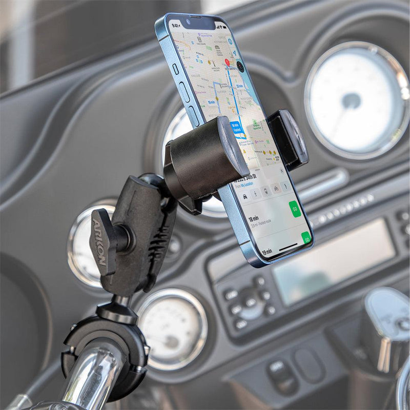 A smartphone displaying a map is mounted on a motorcycle handlebar using the RoadVise® Phone Holder with Aluminum Handlebar Mount and 2.75 Shaft, keeping your device secure while leaving the speedometer and gauges visible in the background.