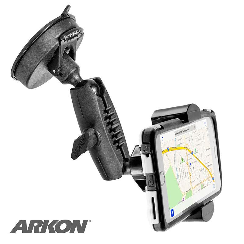 A black RoadVise® Phone Holder with a suction mount and adjustable arm securely holds a smartphone displaying a map navigation app, with the RoadVise® logo in the lower left corner.