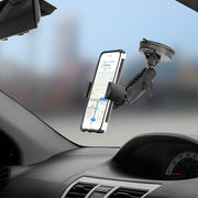 A RoadVise® Phone Holder with Suction Mount and Adjustable Arm secures a smartphone to a car windshield, displaying GPS navigation with the dashboard and speedometer partially visible.