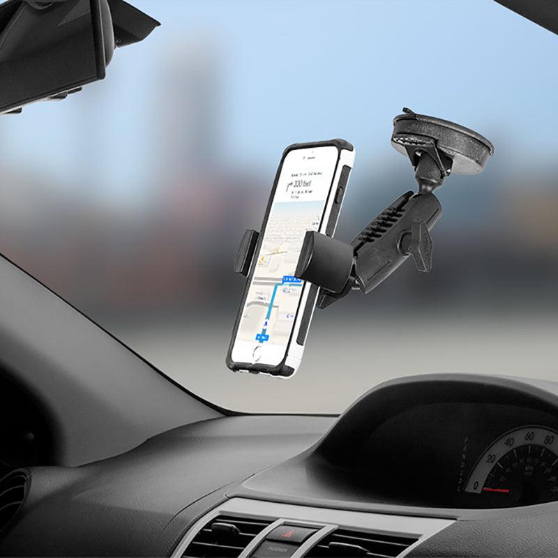 A RoadVise® Phone Holder with Suction Mount and Adjustable Arm secures a smartphone to a car windshield, displaying GPS navigation with the dashboard and speedometer partially visible.