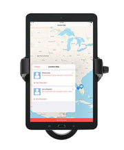 A RoadVise® Ultra Holder with Aluminum Handlebar Mount secures a tablet showing a southeastern US map with two Florida markers, while a wireless charging phone mount nearby enables convenient navigation and address access for smooth travel.