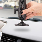 A hand with black nail polish installs a Robust Car Dash or Flat Surface VHB Adhesive Mount on a car dash. The image highlights the curved mount and dashboard details.