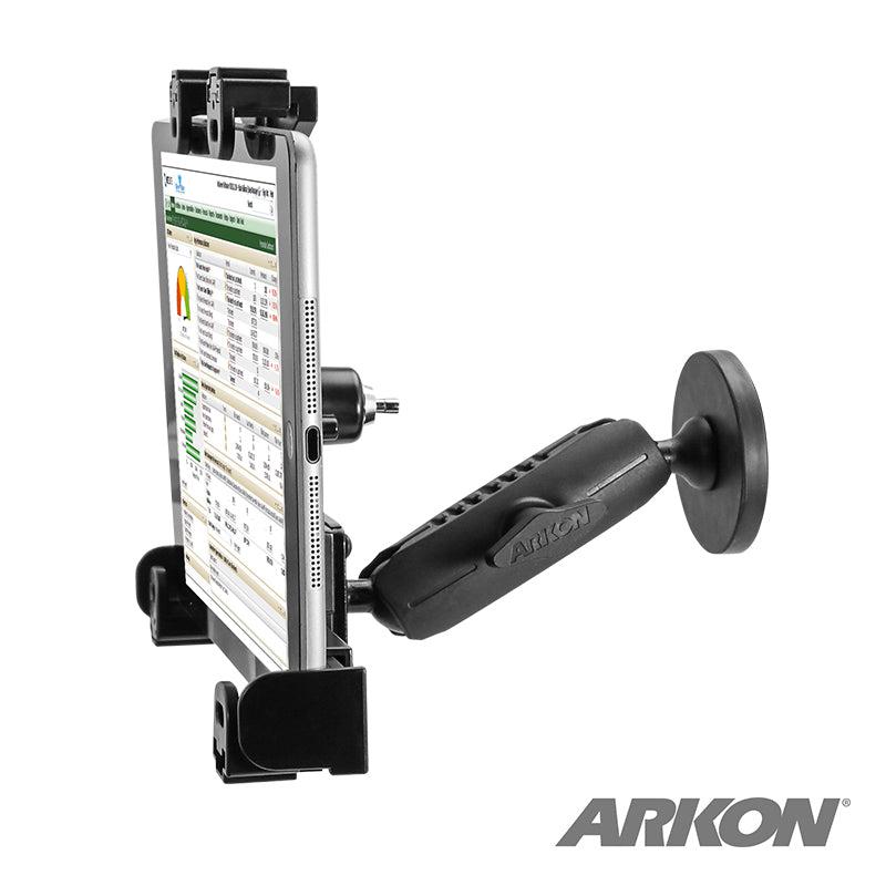 A black LockVise™ Locking Magnetic Tablet Mount with an adjustable arm securely holds a tablet showing a data sheet. The secure mount features the Arkon logo in the bottom right corner.