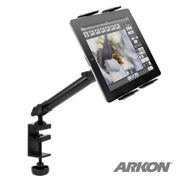 A Slim-Grip® Tablet Holder with Clamp Base and Extension Arm in black holds a tablet showing a butterfly image. The ARKON logo is visible in the bottom right corner.